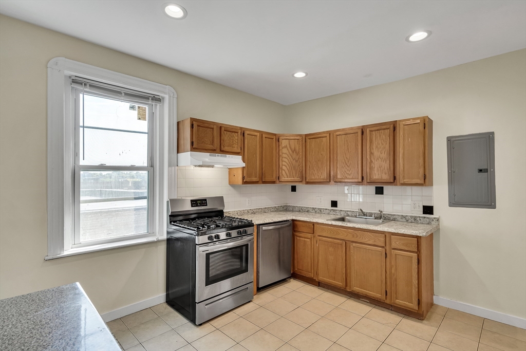41 Orkney Road Boston, MA 02135 - Photo 15 of 28 a kitchen with a sink cabinets and window