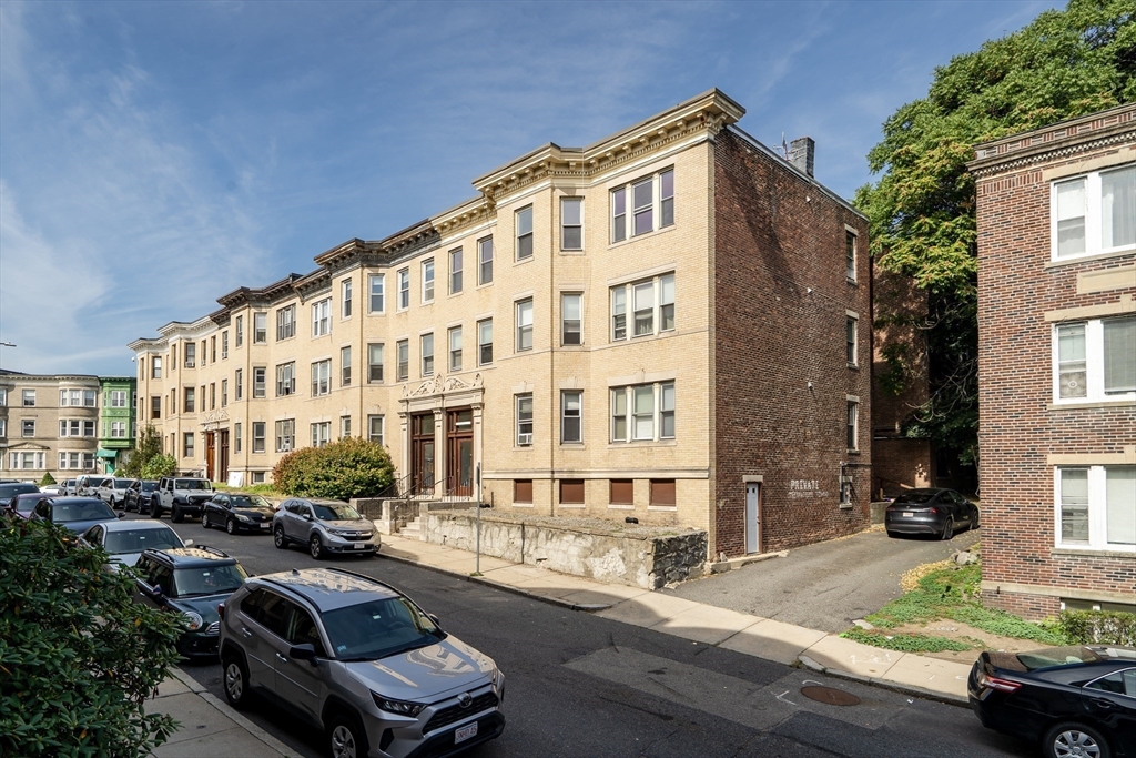 41 Orkney Road Boston, MA 02135 - Photo 2 of 28 a city street lined with parked cars and buildings