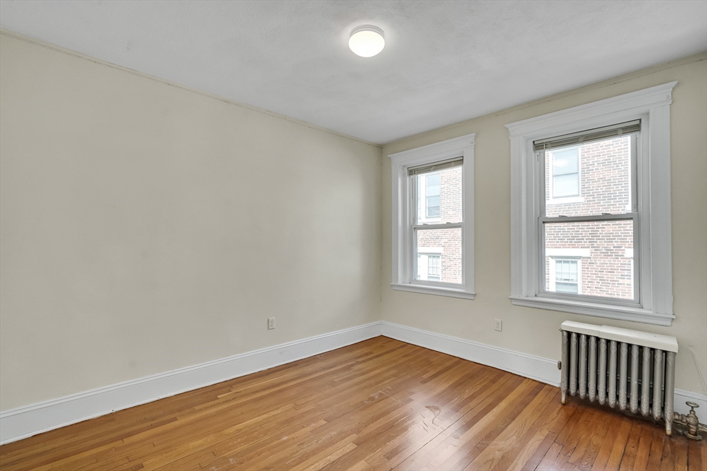 41 Orkney Road Boston, MA 02135 - Photo 25 of 28 an empty room with wooden floor and windows
