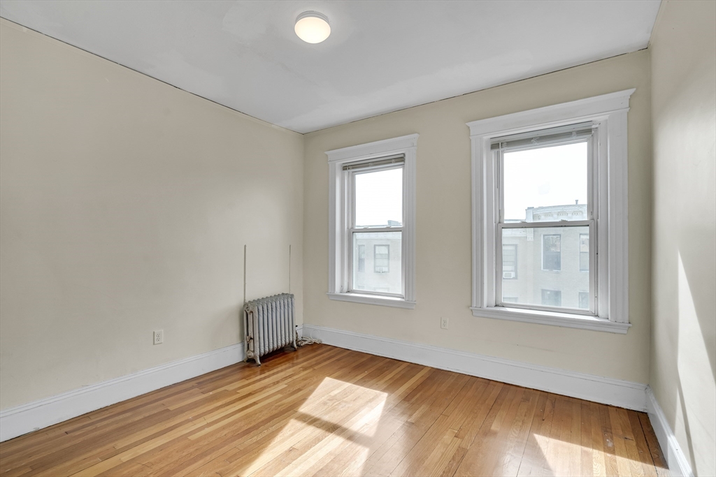41 Orkney Road Boston, MA 02135 - Photo 26 of 28 an empty room with wooden floor and windows
