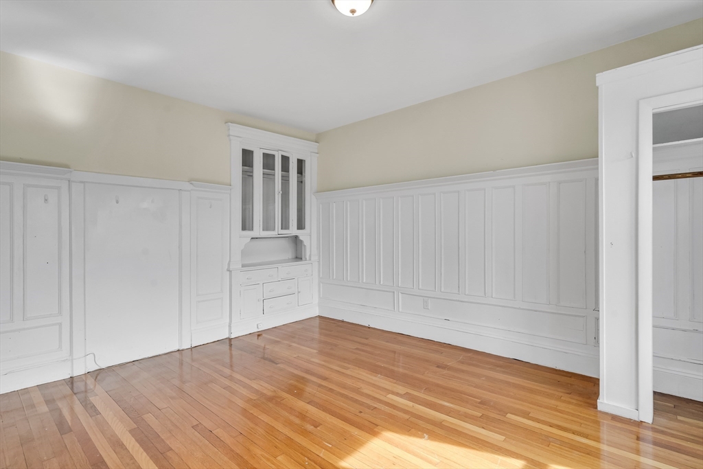 41 Orkney Road Boston, MA 02135 - Photo 9 of 28 a view of empty room with wooden floor and cabinet