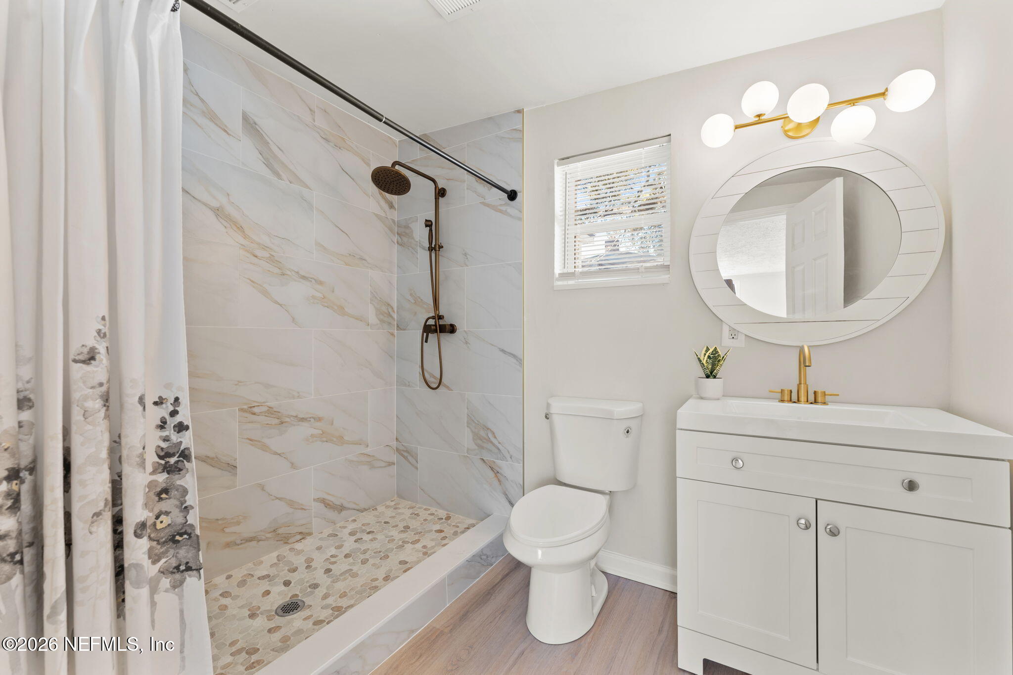 4517 Delta Avenue Jacksonville, FL 32205 - Photo 16 of 25 a bathroom with a sink a toilet and a mirror