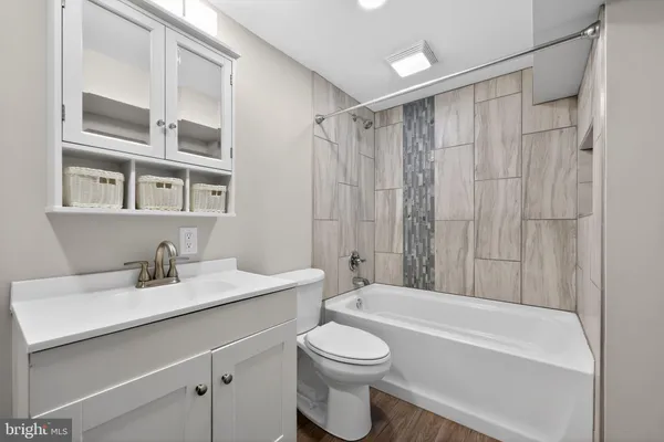 a bathroom with a sink a toilet and a bathtub