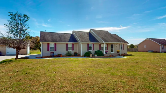 a front view of house with yard and swimming pool