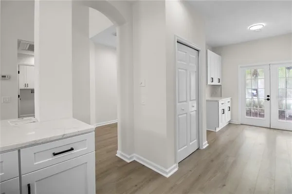 a view of a hallway with wooden floor