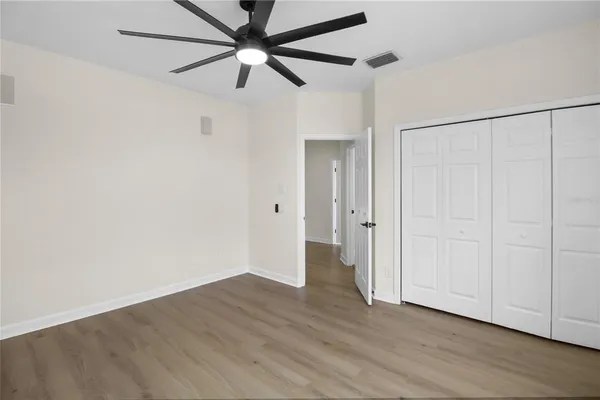 a view of a room with wooden floor