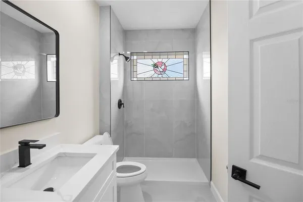 a view of a kitchen with white cabinets and a sink