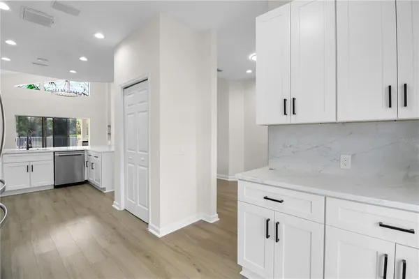 a view of a kitchen with white cabinets and white appliances