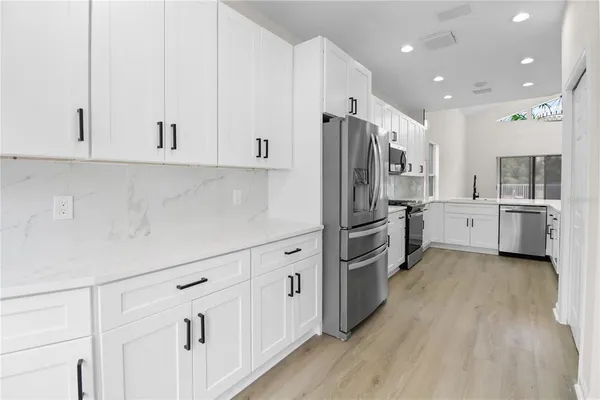 a kitchen with cabinets and stainless steel appliances