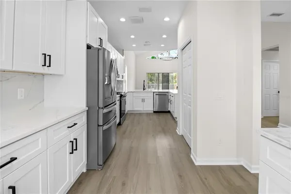 a kitchen with cabinets a sink and wooden floor