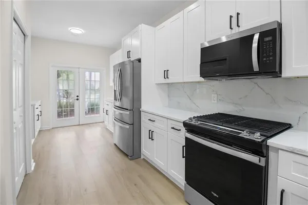 a kitchen with a stove and a microwave