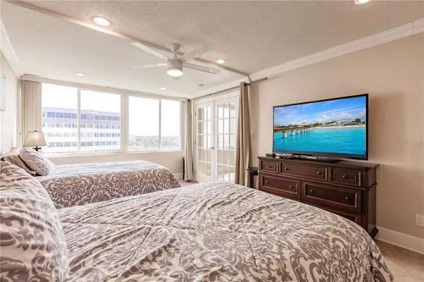 a bedroom with a bed and a flat screen tv