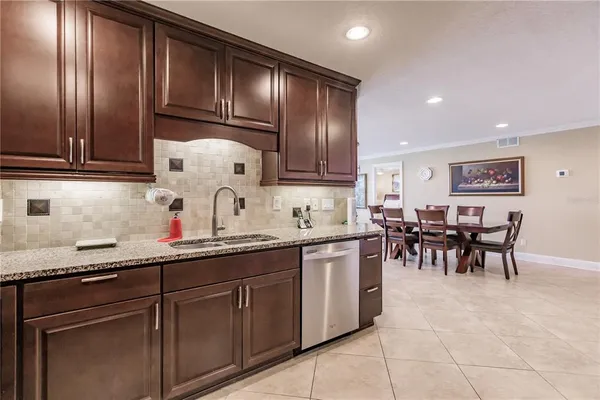a kitchen with cabinets and chairs