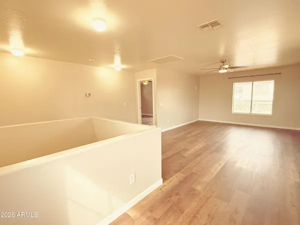 a view of a room with wooden floor