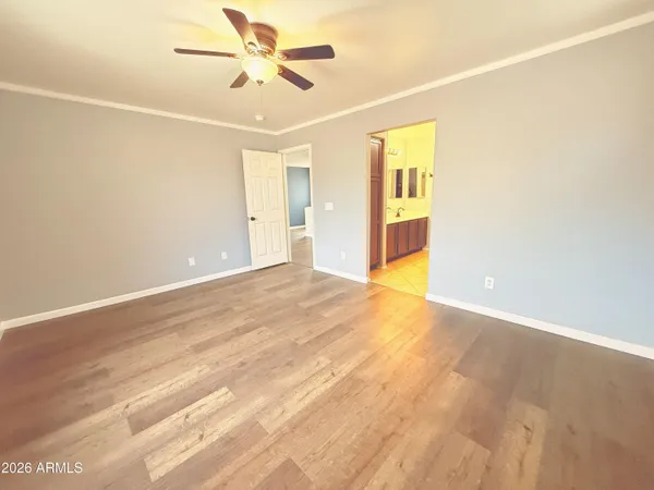 a view of an empty room with wooden floor