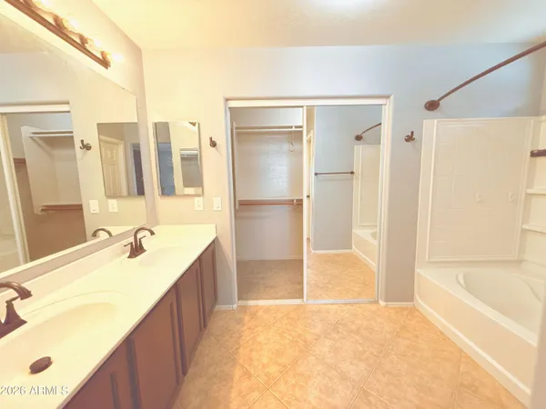 a bathroom with a tub sink and shower