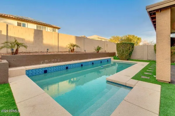 a view of a swimming pool with a lounge chairs