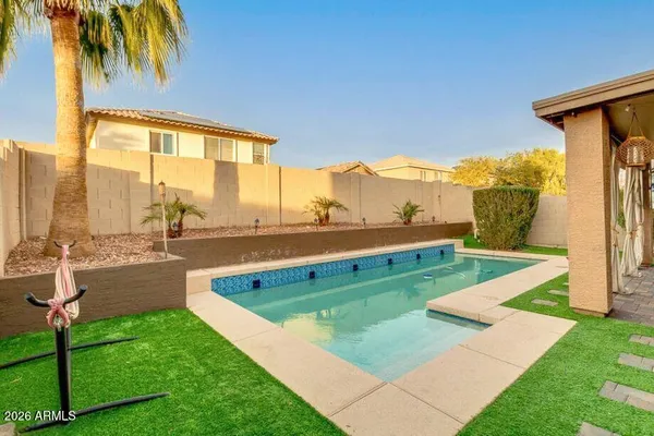 a view of a house with pool and a yard