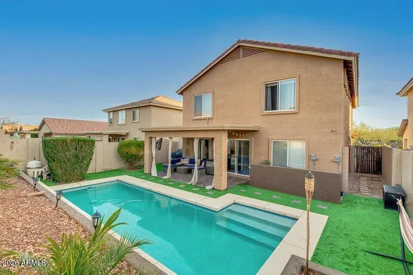 a view of an house with backyard space and porch