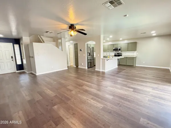 a view of a kitchen with a sink and a refrigerator