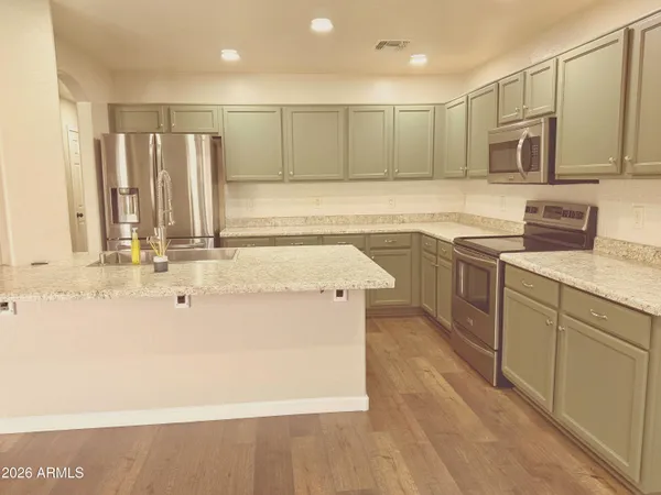 a kitchen with stainless steel appliances granite countertop a sink and cabinets