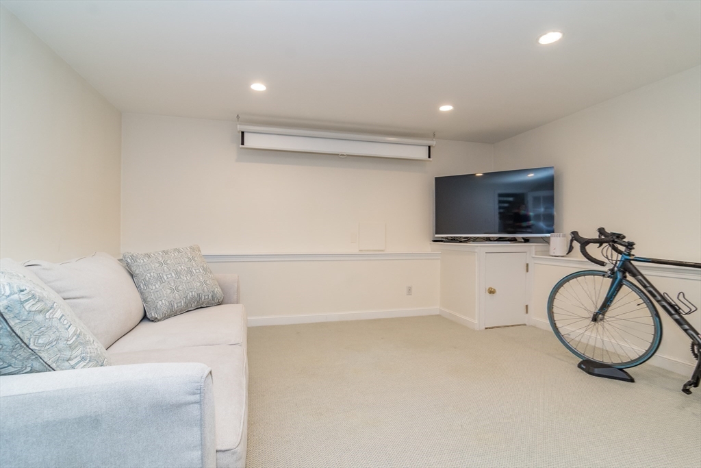 27 Appleby Road Wellesley, MA 02482 - Photo 19 of 23 a living room with furniture and a flat screen tv