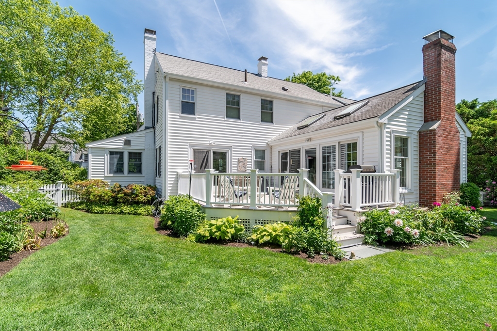 27 Appleby Road Wellesley, MA 02482 - Photo 21 of 23 a front view of a house with a yard and potted plants