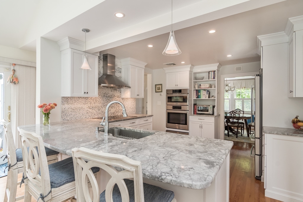 27 Appleby Road Wellesley, MA 02482 - Photo 7 of 23 a kitchen with stainless steel appliances granite countertop a sink and a refrigerator