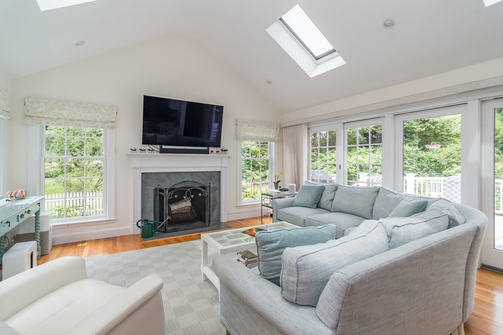 27 Appleby Road Wellesley, MA 02482 - Photo 8 of 23 a living room with furniture a flat screen tv and a fireplace