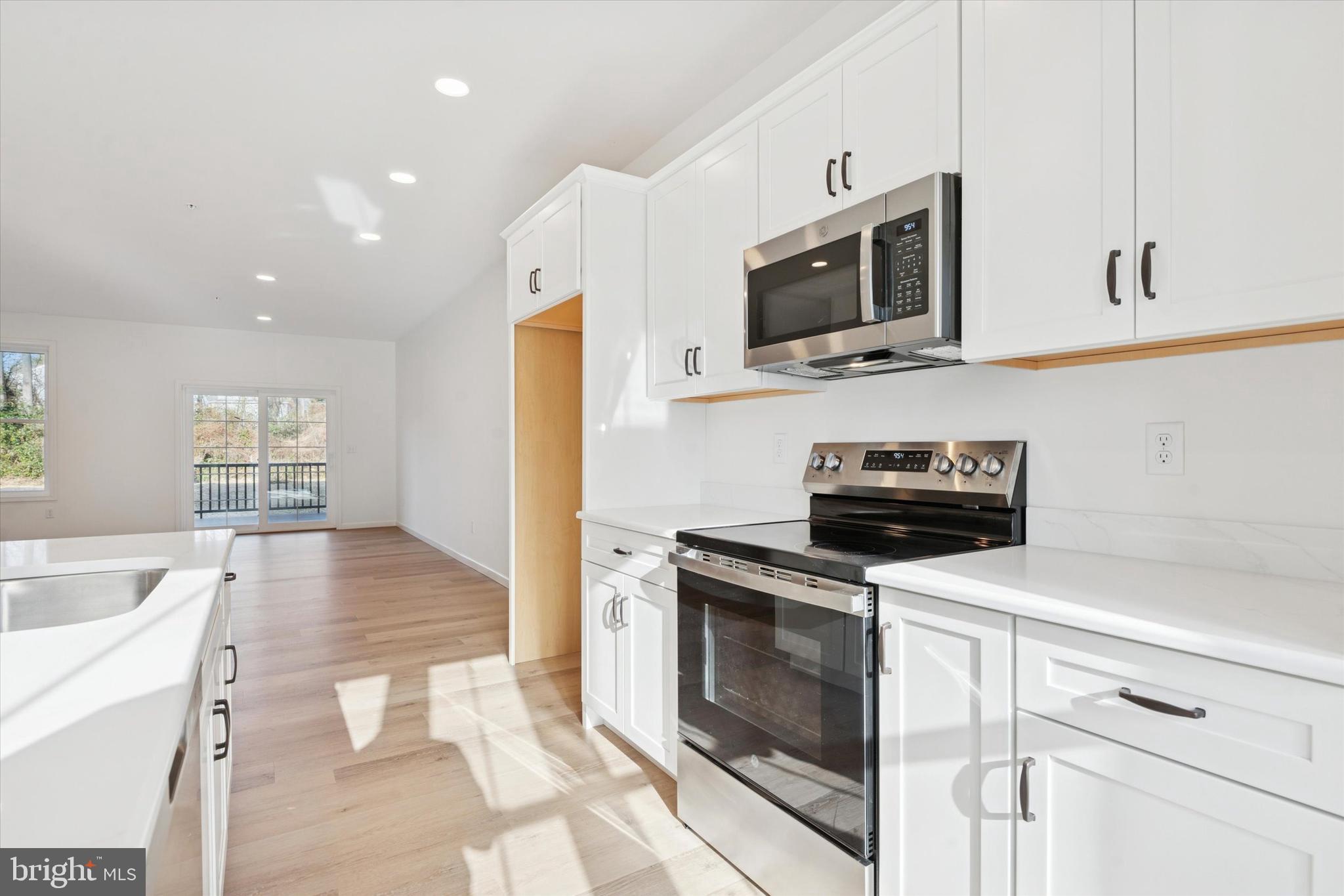 148 Silversmith Road Oxford, PA 19363 - Photo 15 of 20 a kitchen with stainless steel appliances a stove microwave and sink
