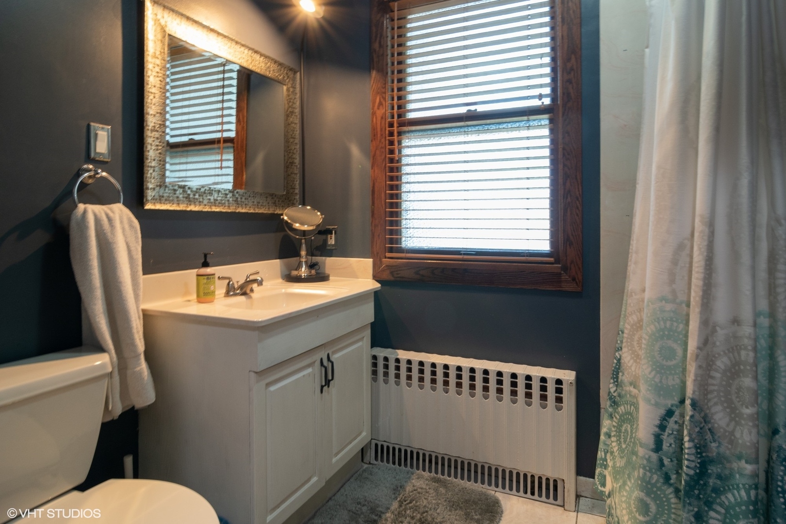 4132 Prairie Avenue Brookfield, IL 60513 - Photo 8 of 10 a bathroom with a sink a toilet and a window