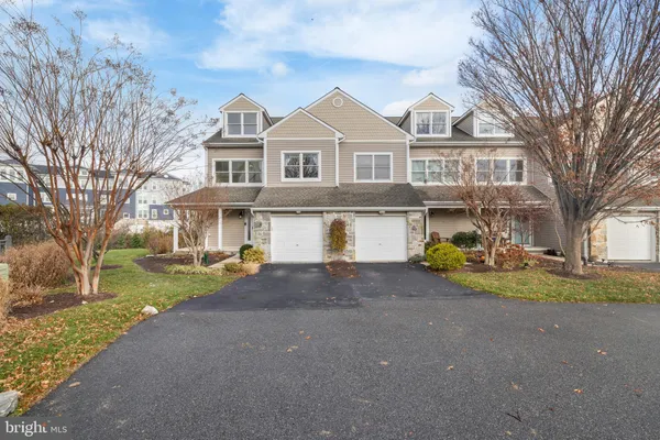 a front view of a house with garden and porch