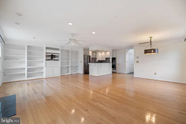 a kitchen with stainless steel appliances granite countertop a refrigerator sink and stove