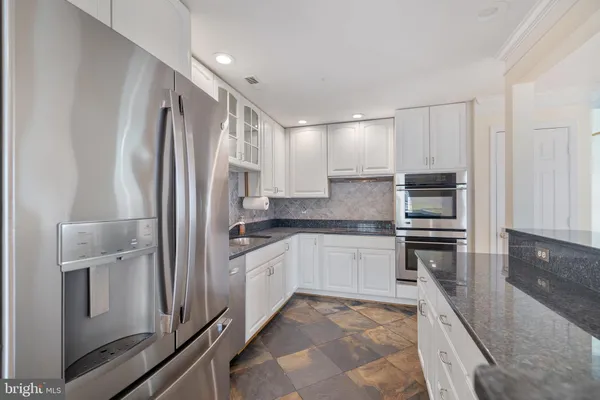 a large white kitchen with a large window