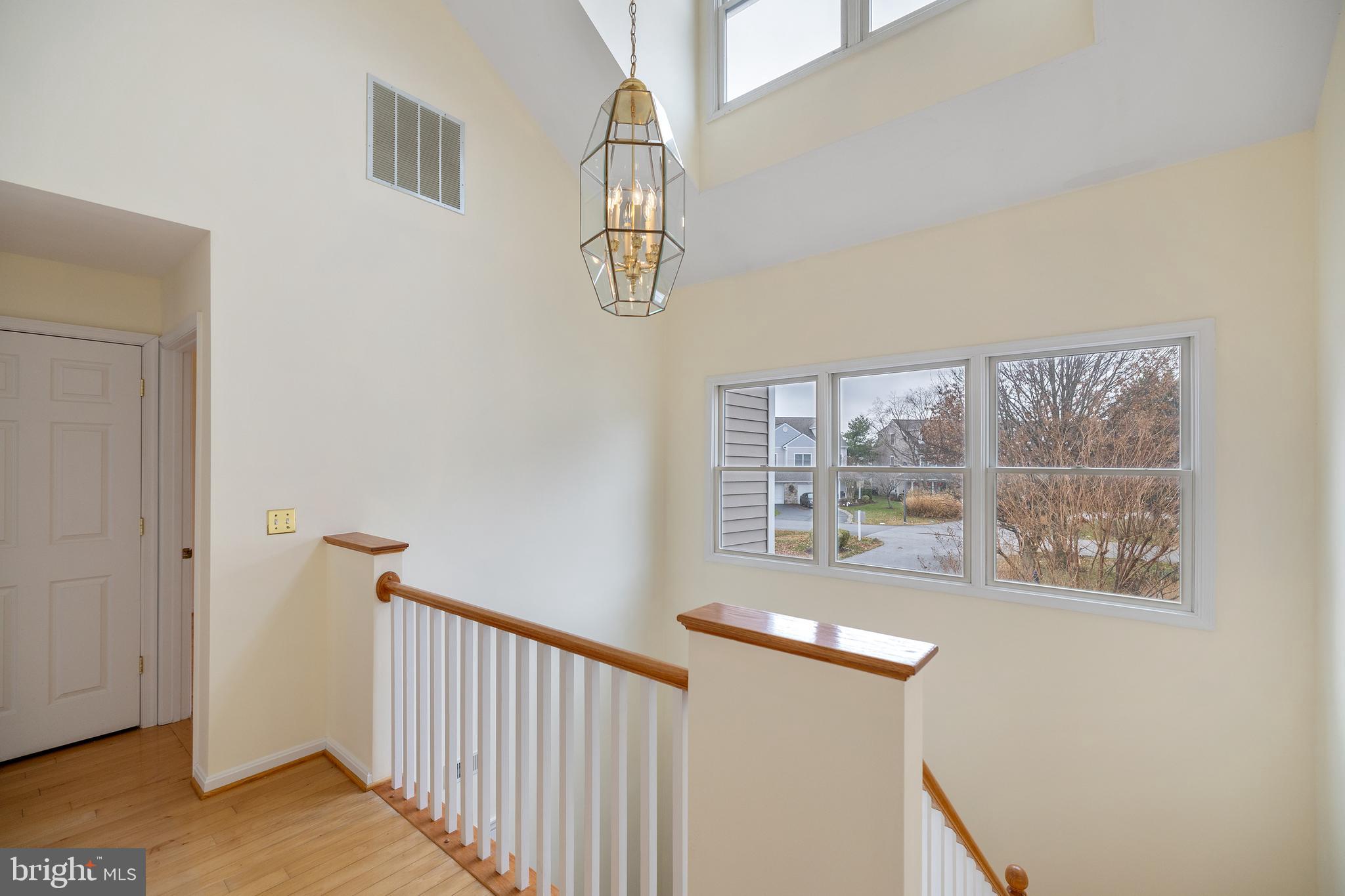 807 Auckland Way Chester, MD 21619 - Photo 19 of 47 a view of entryway with wooden floor and chandelier