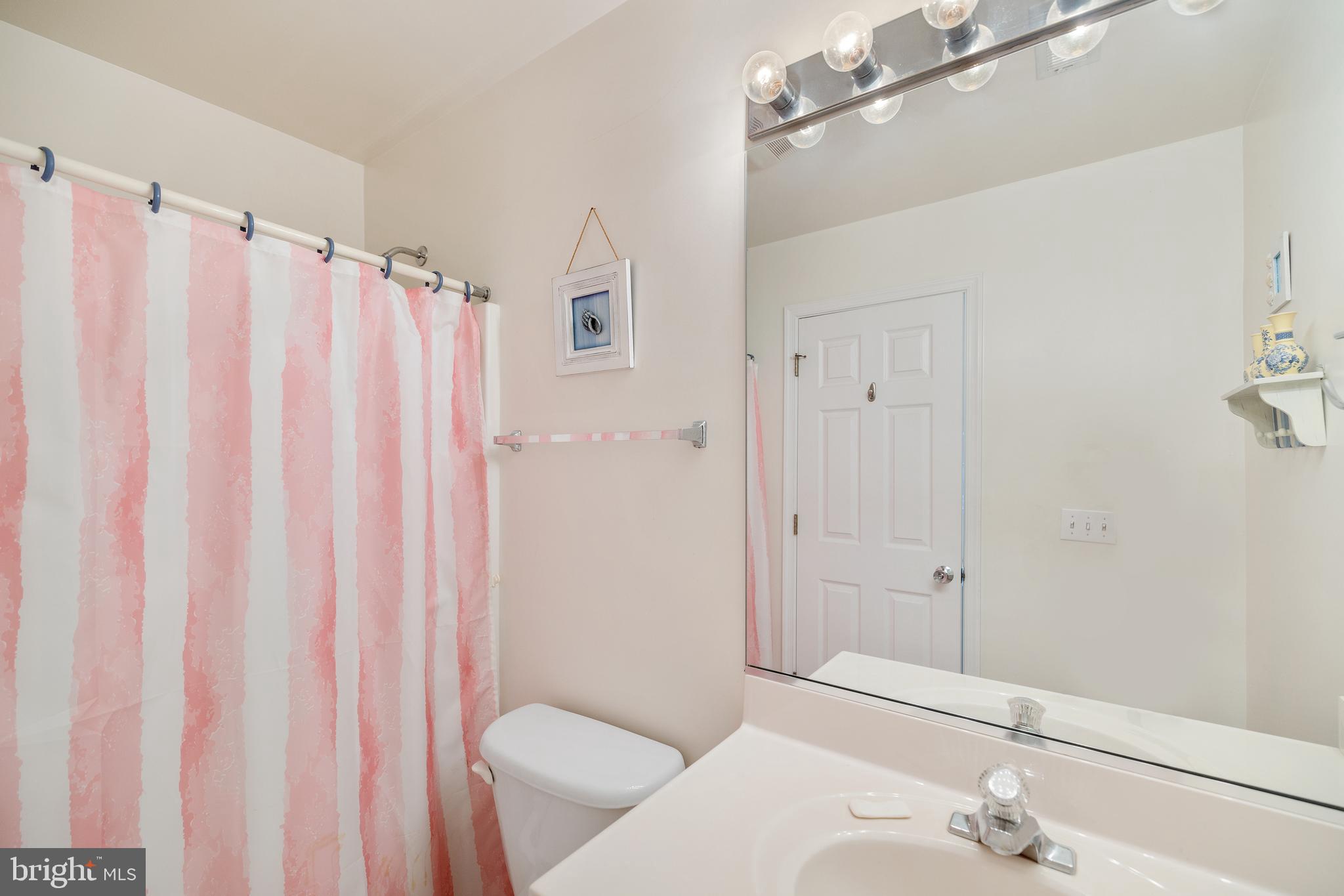 807 Auckland Way Chester, MD 21619 - Photo 24 of 47 a bathroom with a sink and a mirror