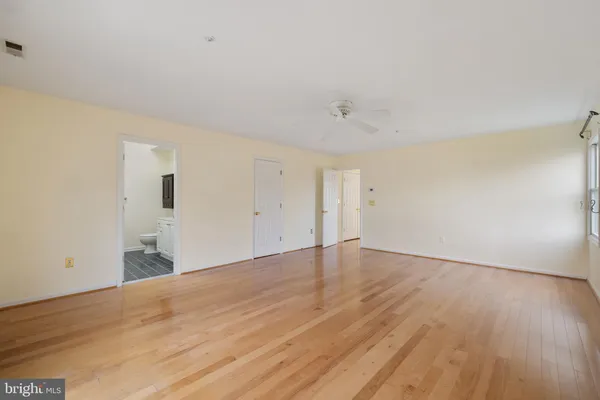 a view of an empty room and wooden floor