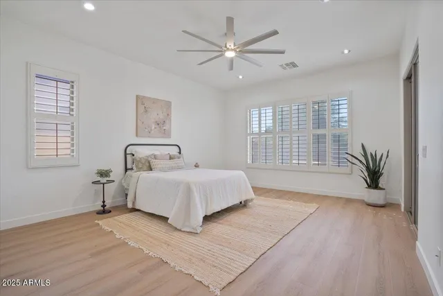 a spacious bedroom with a large bed and a large window