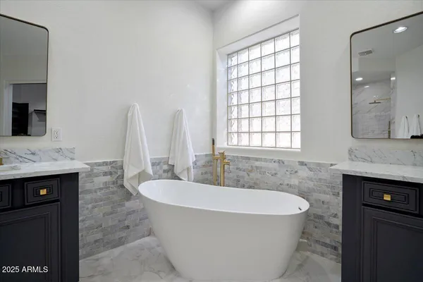 a bathroom with a bathtub and a sink