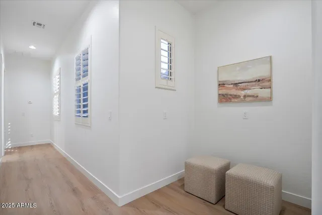 a view of room with window and wooden floor