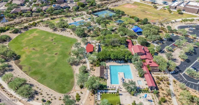 an aerial view of a house with a yard