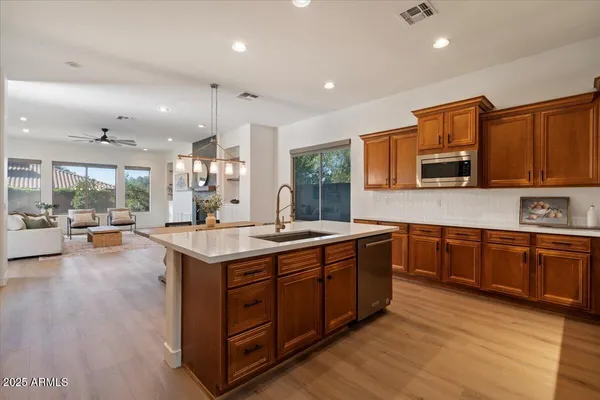 a kitchen with a stove a sink and a refrigerator