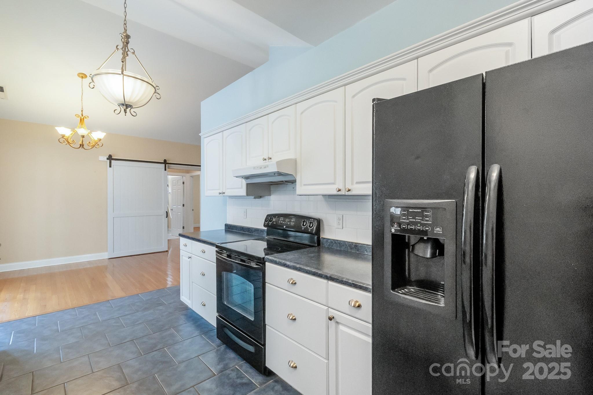 13221 Brandywine Lane Midland, NC 28107 - Photo 11 of 34 a kitchen with stainless steel appliances granite countertop a refrigerator a stove and a sink with wooden floor