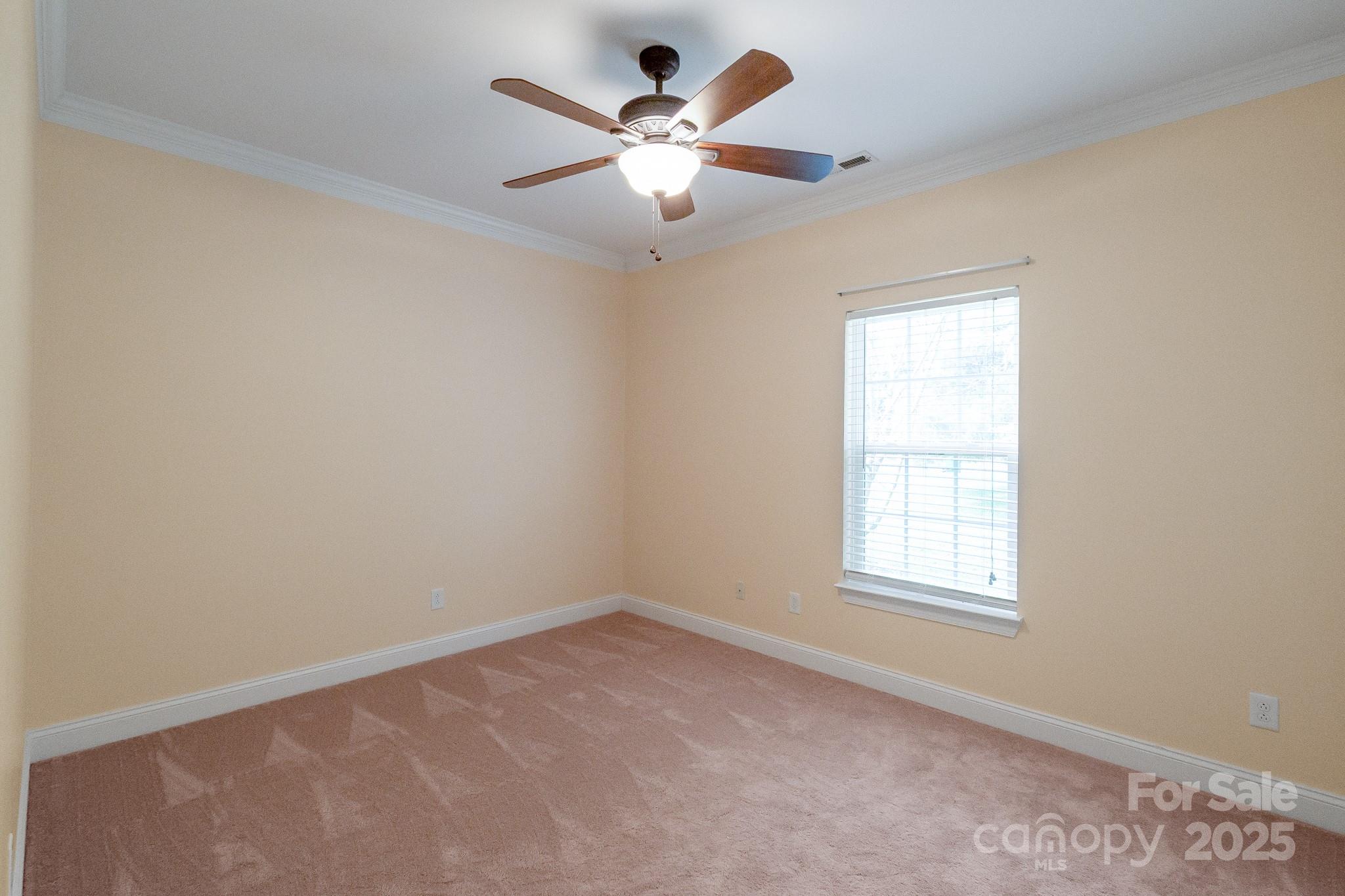 13221 Brandywine Lane Midland, NC 28107 - Photo 16 of 34 an empty room with a window and a ceiling fan