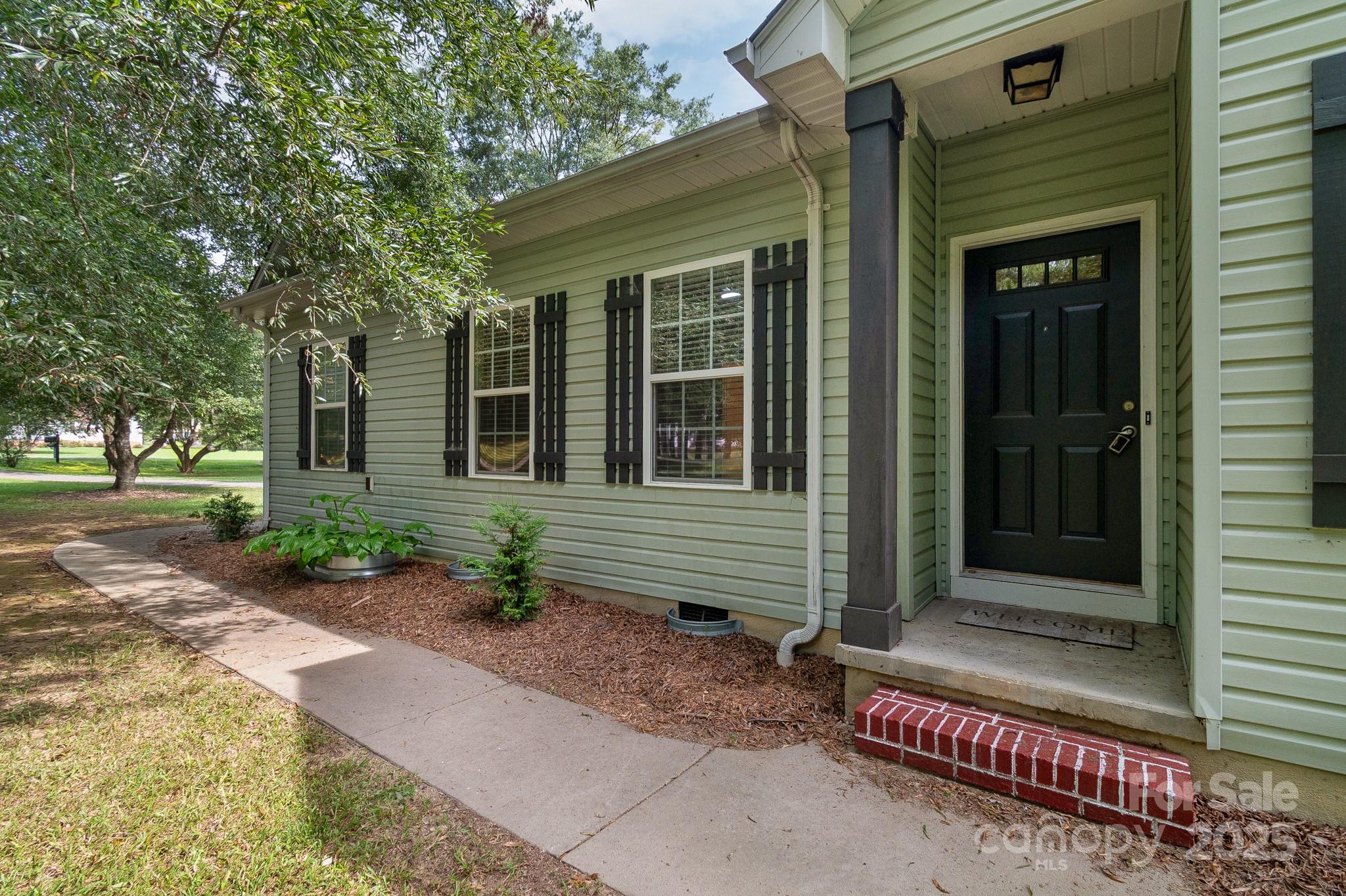 13221 Brandywine Lane Midland, NC 28107 - Photo 2 of 34 a front view of a house with garden