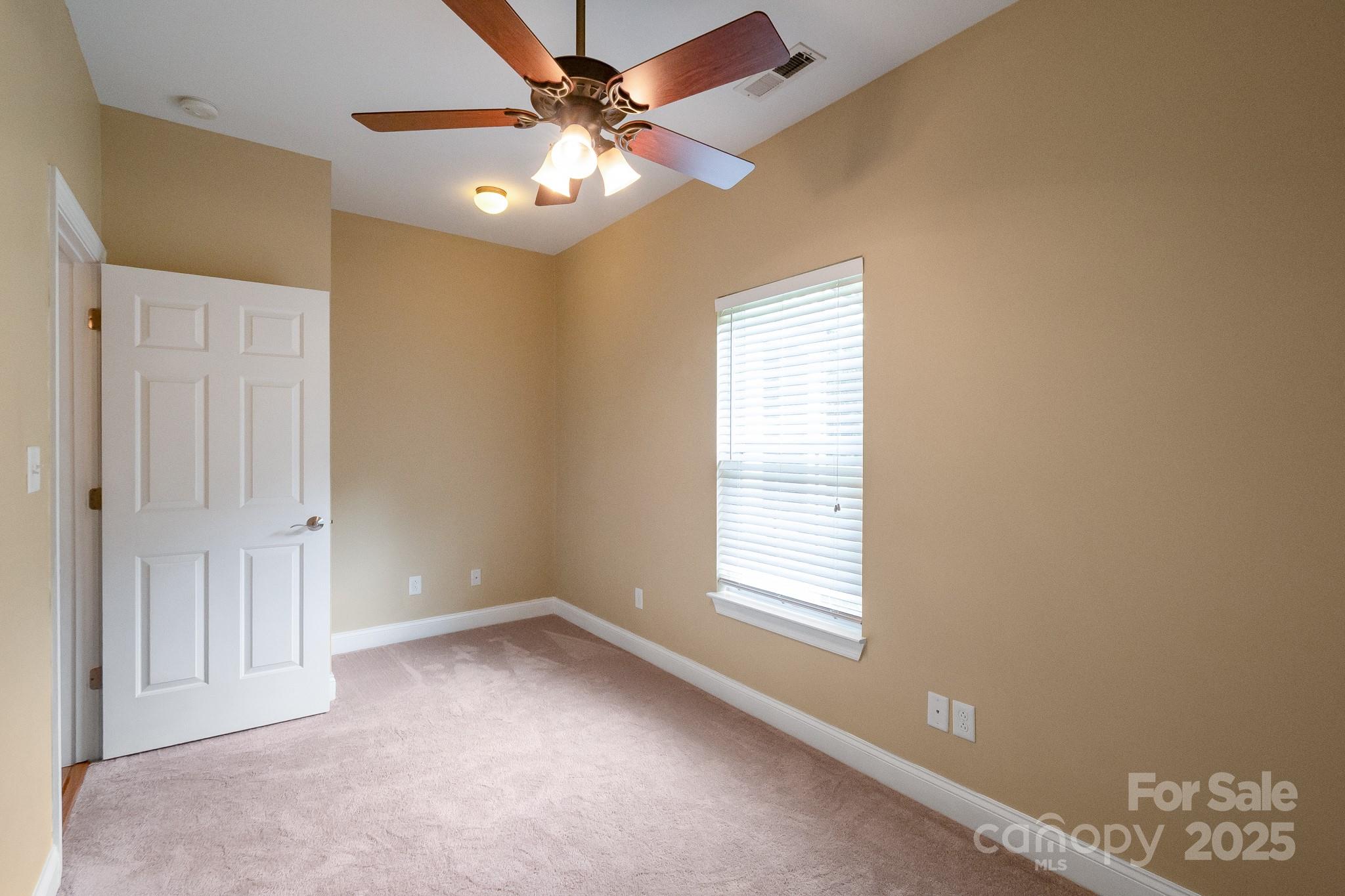 13221 Brandywine Lane Midland, NC 28107 - Photo 22 of 34 an empty room with windows and fan