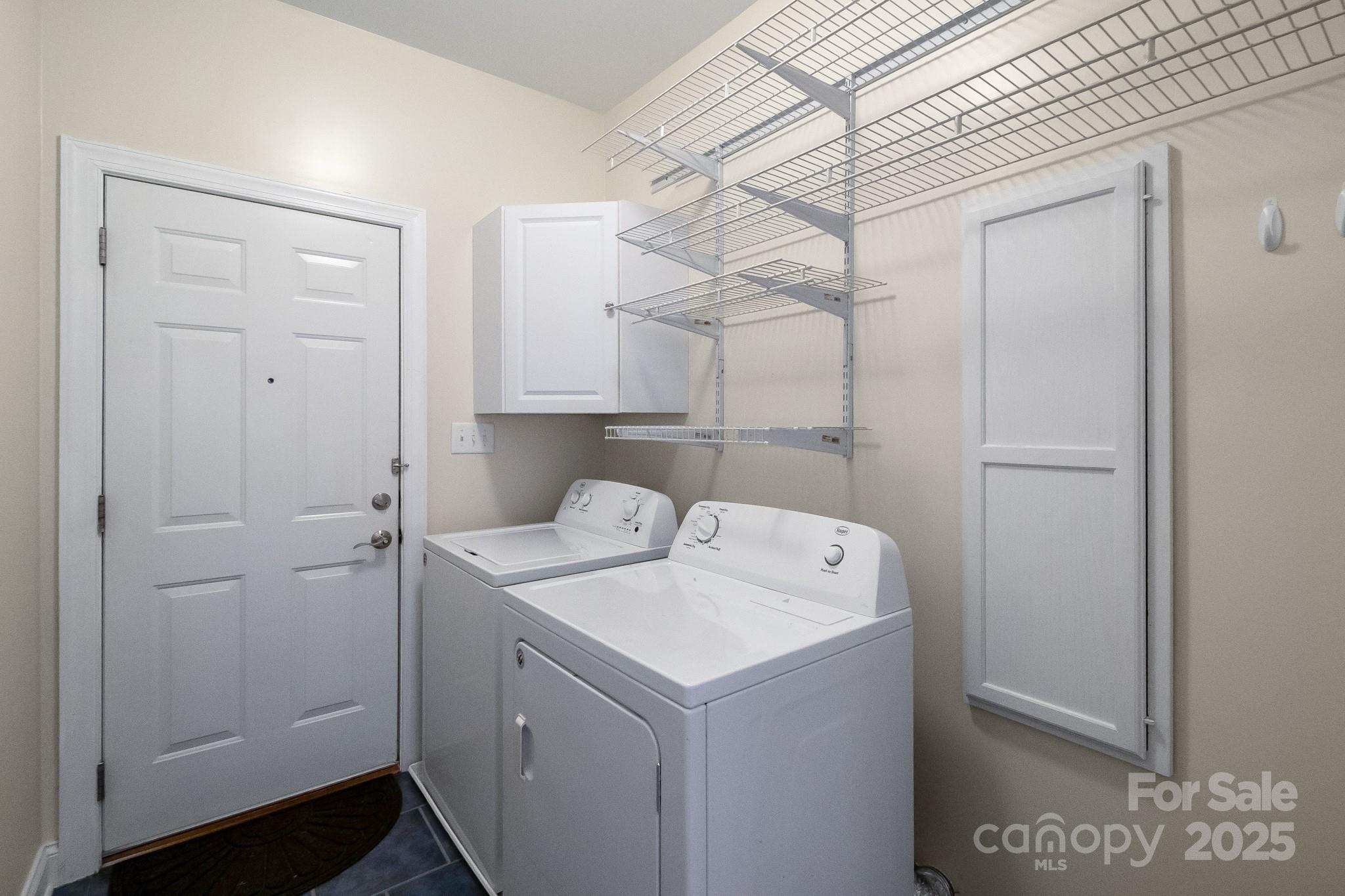 13221 Brandywine Lane Midland, NC 28107 - Photo 23 of 34 a utility room with cabinets washer and dryer
