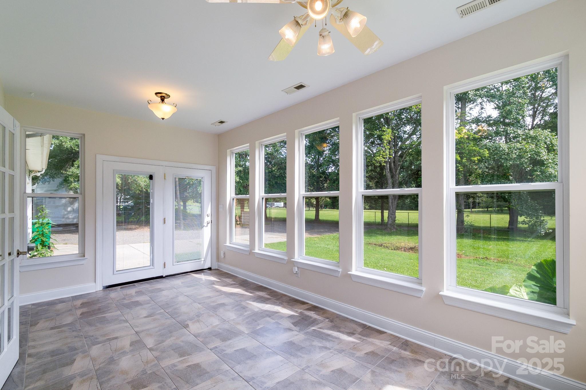 13221 Brandywine Lane Midland, NC 28107 - Photo 27 of 34 a view of empty room with floor to ceiling windows and yard