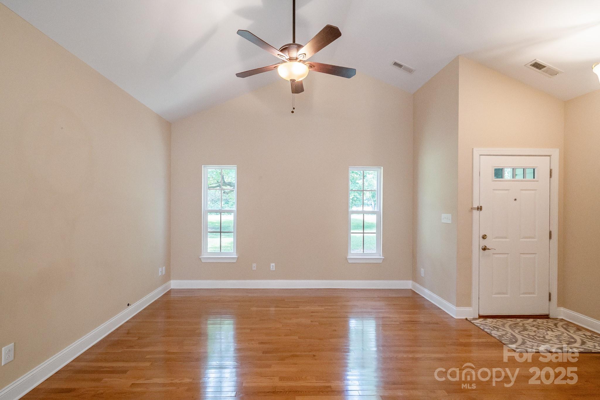13221 Brandywine Lane Midland, NC 28107 - Photo 5 of 34 a view of an empty room with window and wooden floor