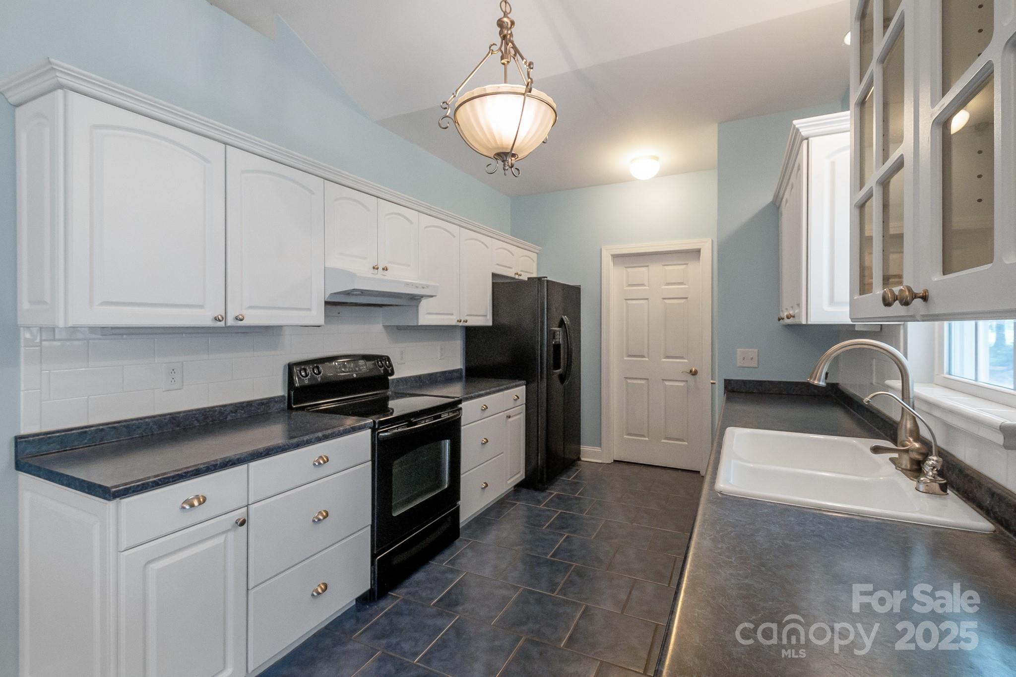 13221 Brandywine Lane Midland, NC 28107 - Photo 9 of 34 a kitchen with stainless steel appliances granite countertop a sink a stove and a refrigerator